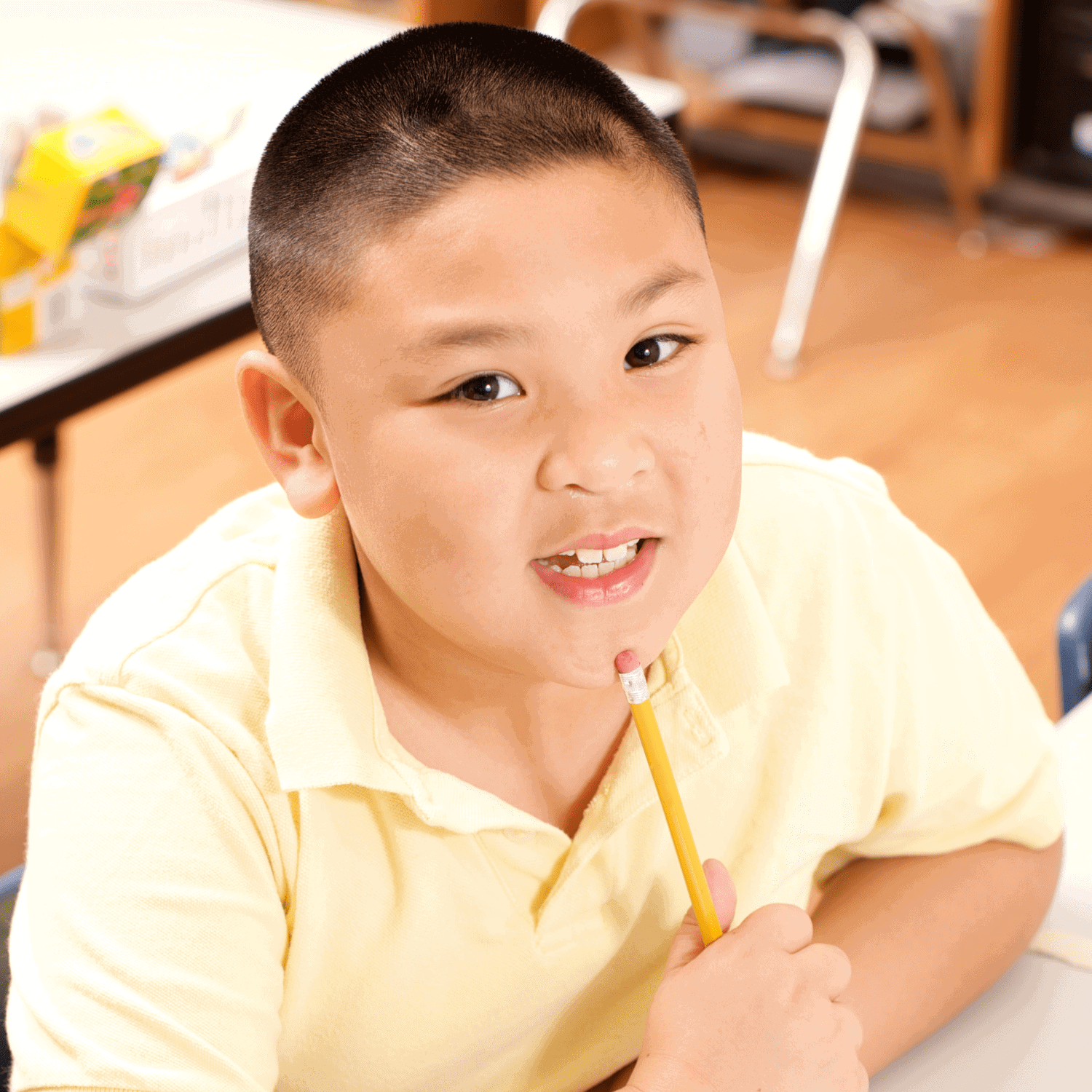 Child sitting at his desk in classroom